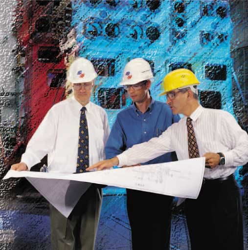 three_engineers_in_hard_hats_with_map.jpg